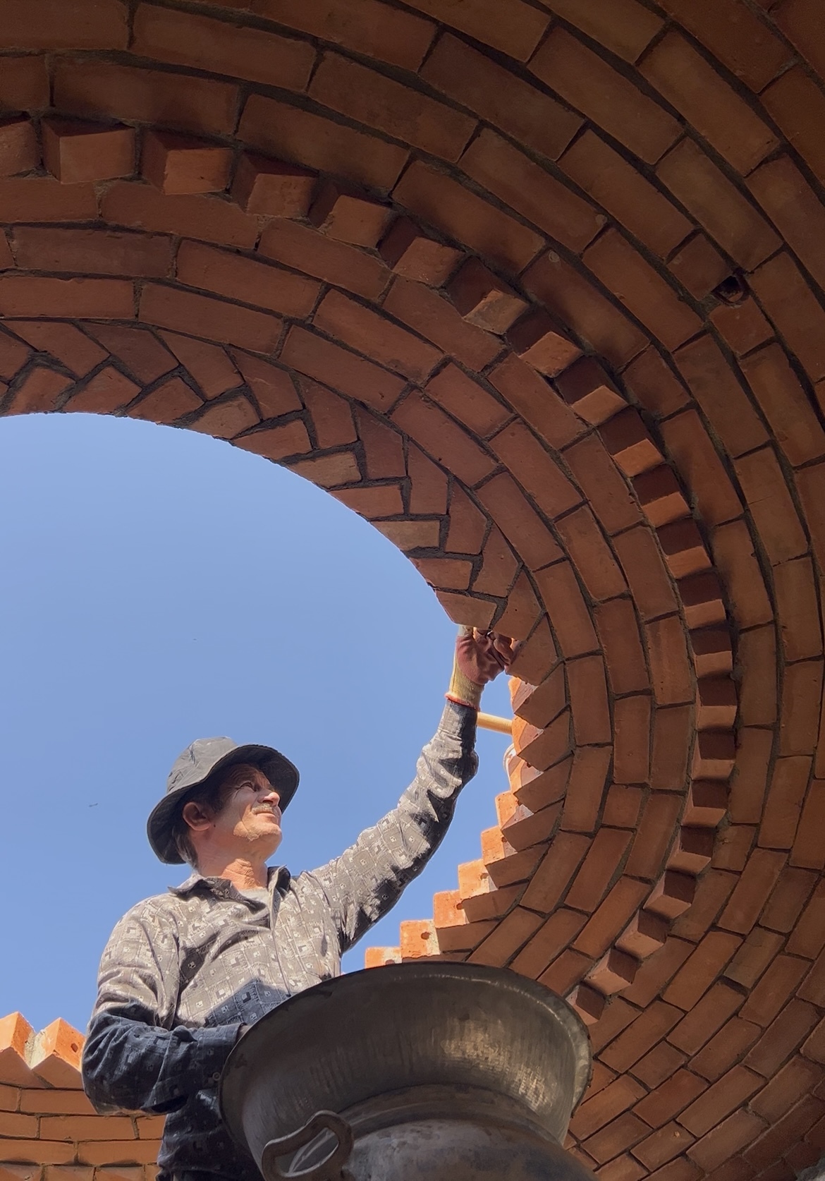 Craftsman applying finishing to circular dome arch - Rohtak Domes 2025