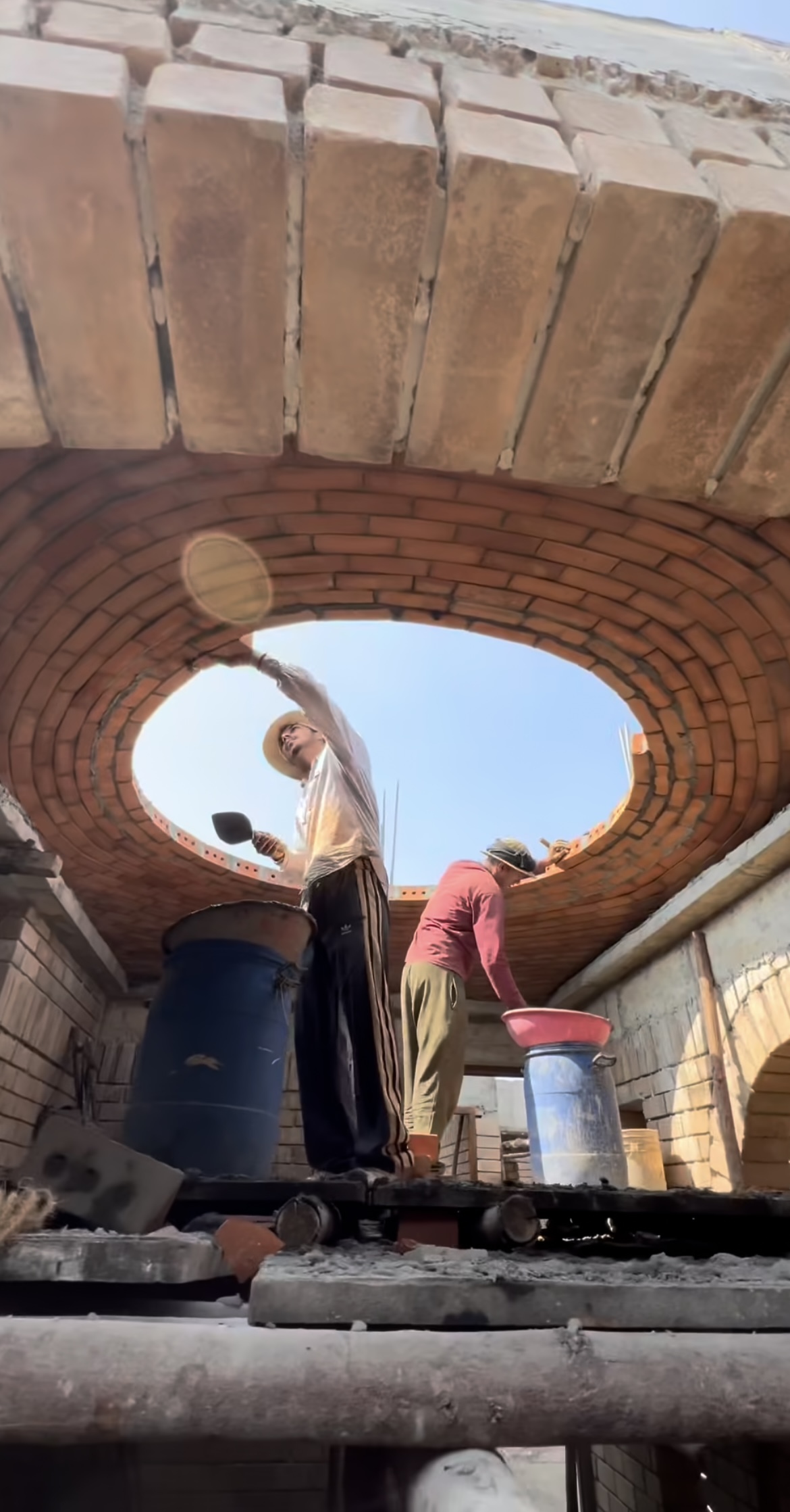 Workers constructing circular dome with central opening - Rohtak Domes 2025
