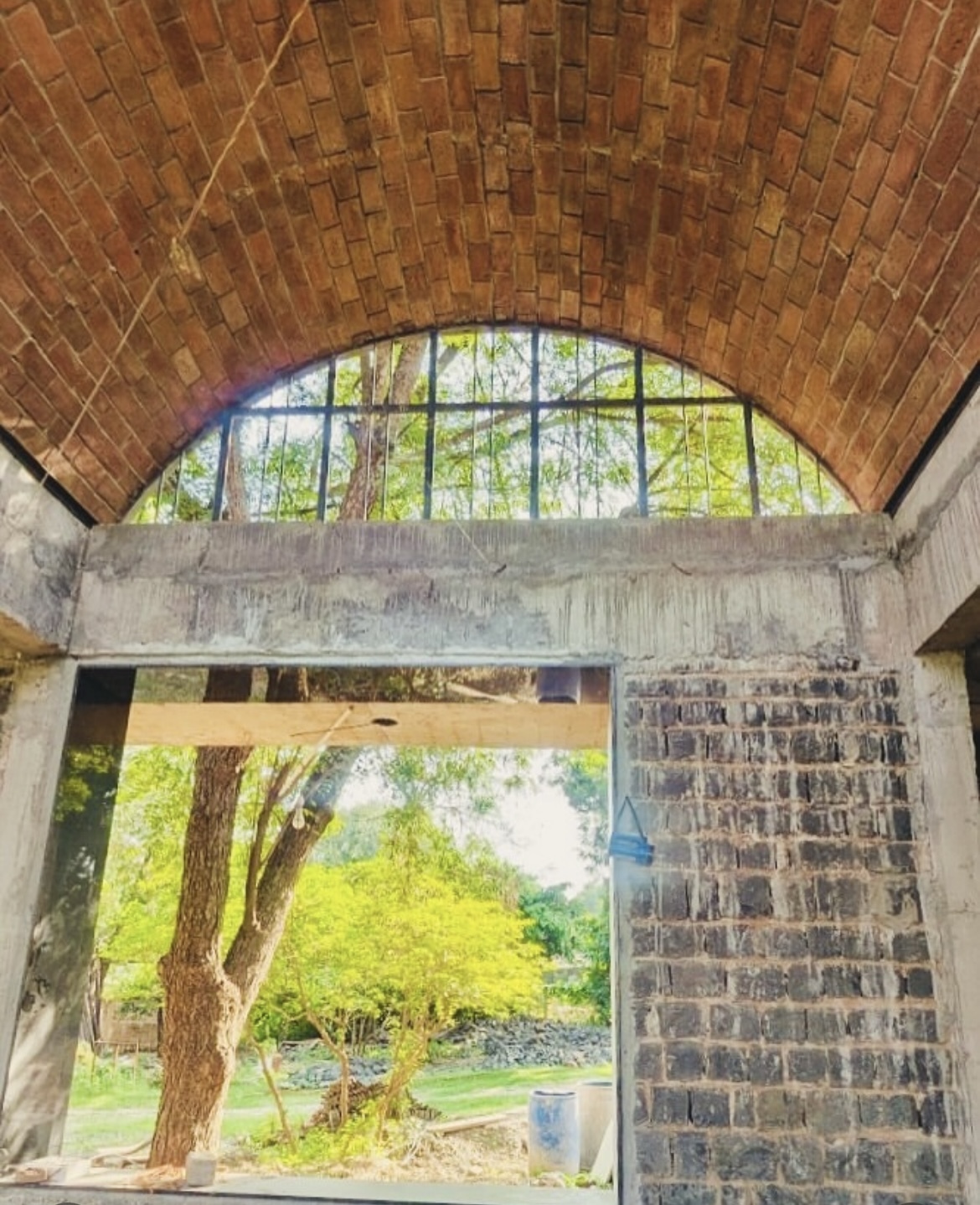 Brick barrel vault with arched window and natural light - Rohtak Domes 2024